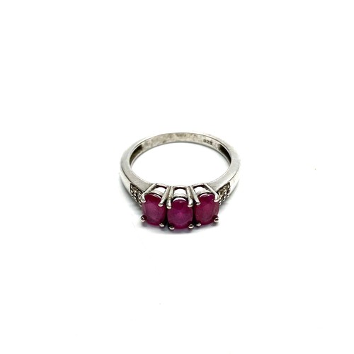 940 - Silver ring with Rubies and diamond shoulder stones, size O.