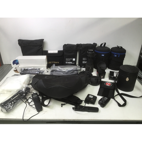 345 - A quantity of camera equipment including a Sigma lens, lens cases and RT softbox