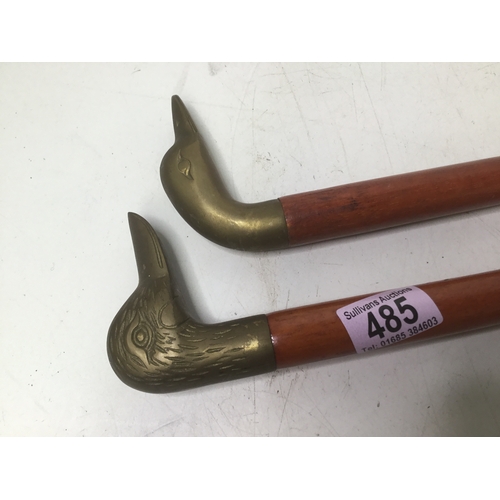 485 - Two walking sticks with brass duck head handles