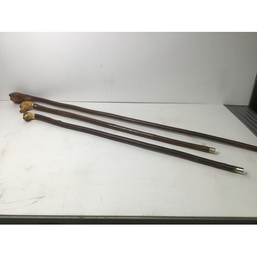 486 - Three walking sticks with dogs head handles