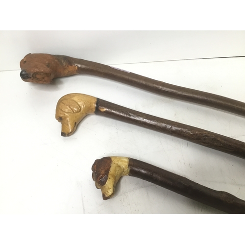 486 - Three walking sticks with dogs head handles