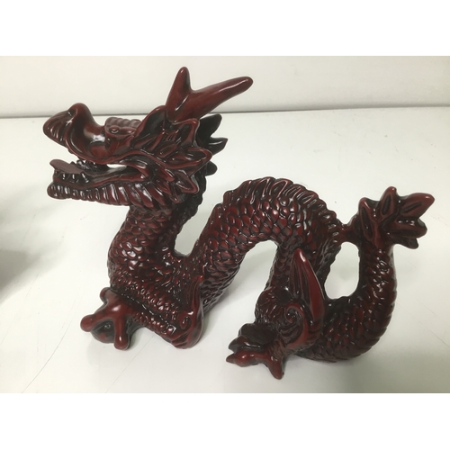 689 - Two Chinese resin sculptures Foo dog lion and a guardian Dragon