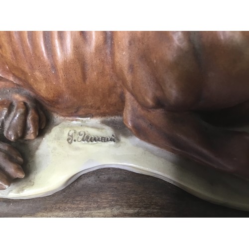 709 - Guissepe Armani dog sculpture on a wooden plinth 25cm x 18cm