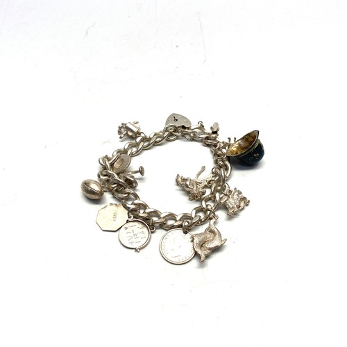 897 - Silver charm bracelet and 13 charms.