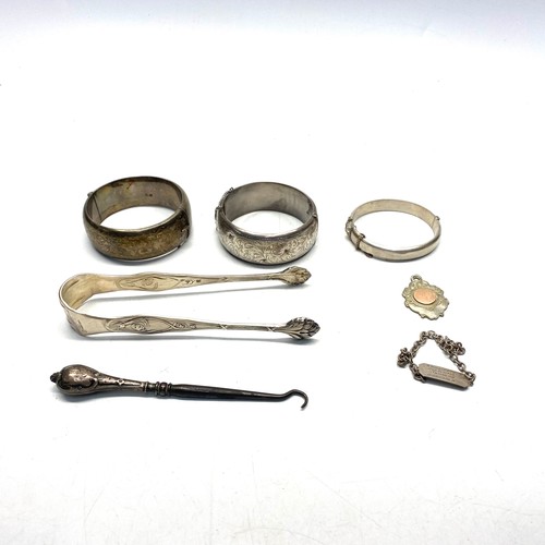 898 - Two sterling silver bangles, pair of Portuguese silver plate Art-Nuevo sugar nips, and other silver ... 