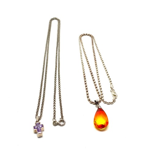 722 - Two long silver chains and pendants.