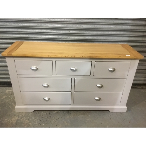 9 - Large modern seven drawer chest of drawers in grey with a wooden top 141cm x 43cm x 78cm