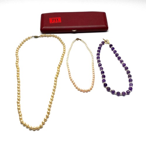 711 - Pearls and a pearl and semi precious stone necklaces.