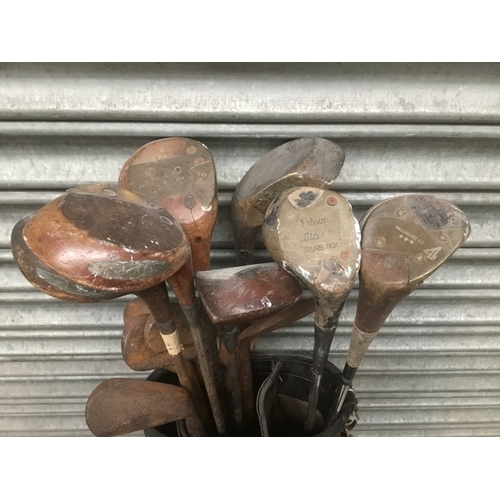 299 - Vintage wooden golf clubs with bag