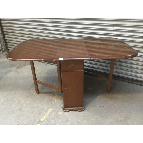 61 - Drop leaf table with drawers and cupboard beneath