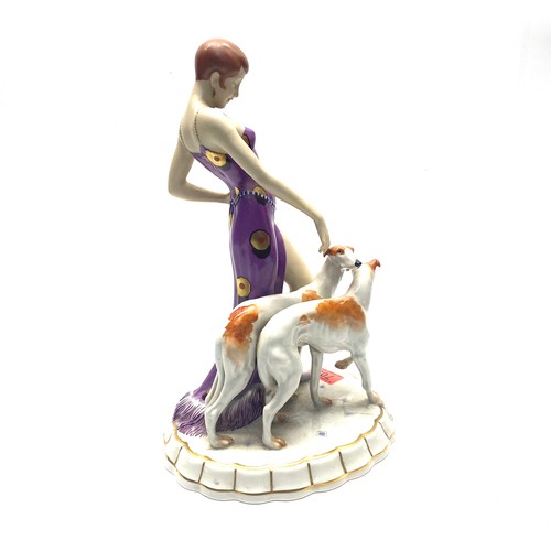 709 - Royal Dux Art Deco figure of a maiden wearing a flapper dress with two Borzoi dogs. Pink RD stamp to... 