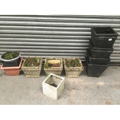 125 - Three concrete planters and a selection of plastic pots