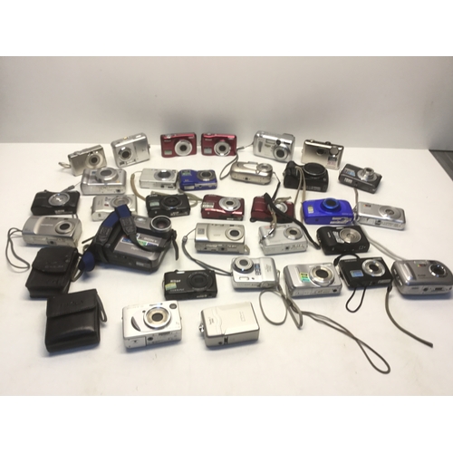 1153 - A large quantity of digital cameras including Sony, Canon and Olympus