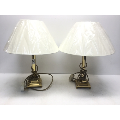 262 - A pair of brass lamps with art deco styled bases