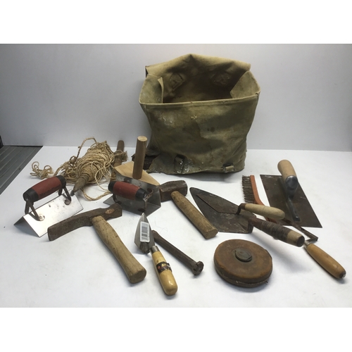 263 - A selection of bricklayers tools in a rucksack includes Marshalltown trowels