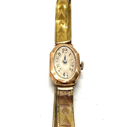 867 - 9ct rose gold ladies watch with a rolled gold strap.