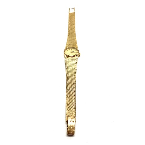 873 - 9ct gold ladies Omega Deville oval  face watch and strap. Running when booked in. Total weight with ... 