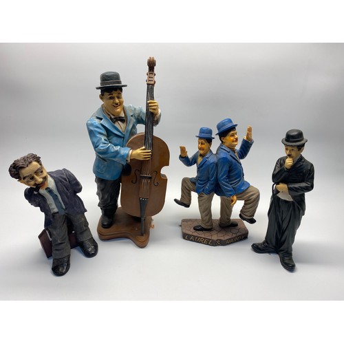 85A - A selection of collectible figures including Laurel and Hardy and Charlie chaplain