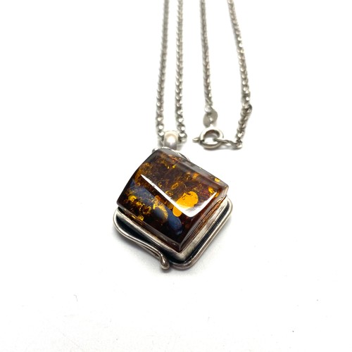 805 - Stunning amber pendant in a hand made silver frame and long silver necklace.