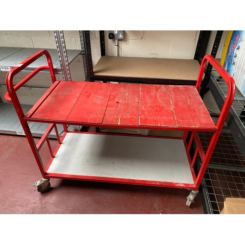 55A - Large red four wheeled trolley.