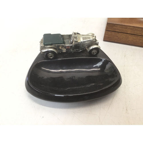 706 - Two vintage ashtrays with cars and a cigarette box