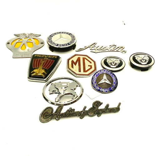 856 - Collection of car badges including: Rover, Jaguar and Mercedes Benz.