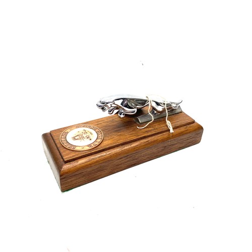 867 - Jaguar car mascot mounted on a wooden base.