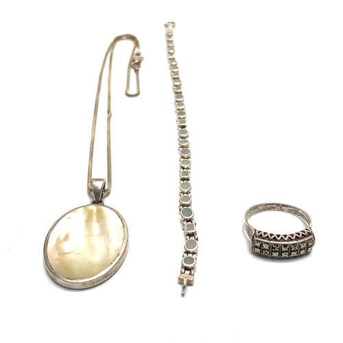 965 - Silver bracelet with moon stones, (show as blue in the dark), silver pendant and chain and a Masonit... 