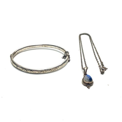 973 - Sterling silver Rainbow moonstone solitaire pendant and chain and a sterling silver bangle.