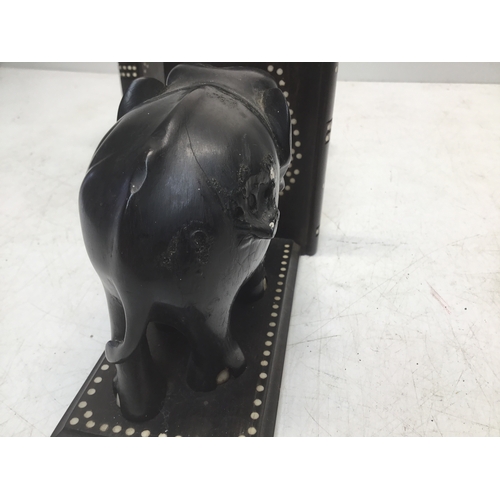 895 - A pair of black ebonised elephant bookends with faux ivory inserts (slight damage)