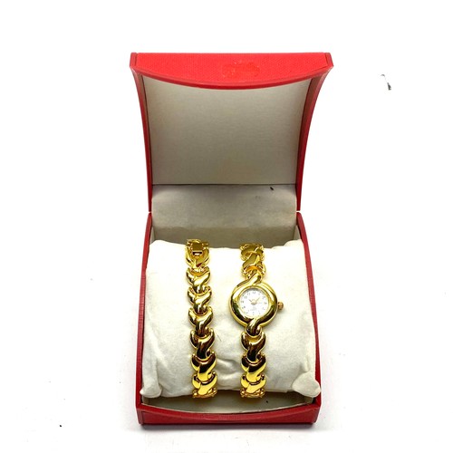 909 - Jean Louis ladies Scherrer gold plated watch and bracelet set.