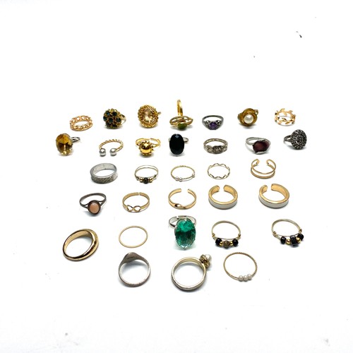 915 - Over 30 gold tone and silver ring.