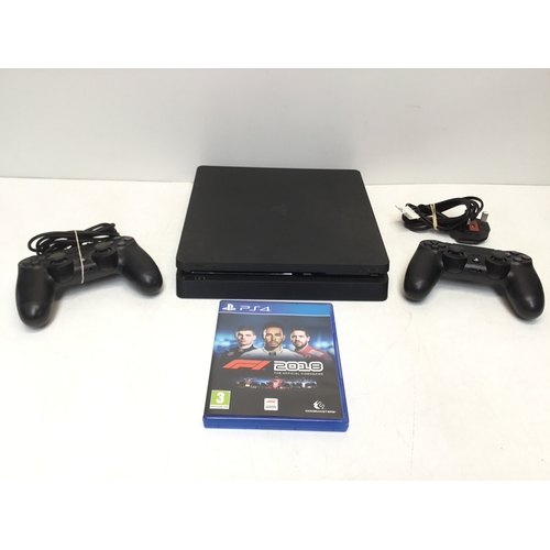 1351 - PlayStation 4 with controllers and game
