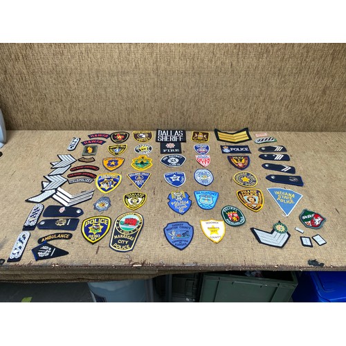 1200 - collection of police memorabilia including patches, shoulder titles, and epaulettes.