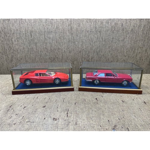 1310 - 2 model cars on wooden plinths in glass cases including: Ferrari and Rolls Royce.