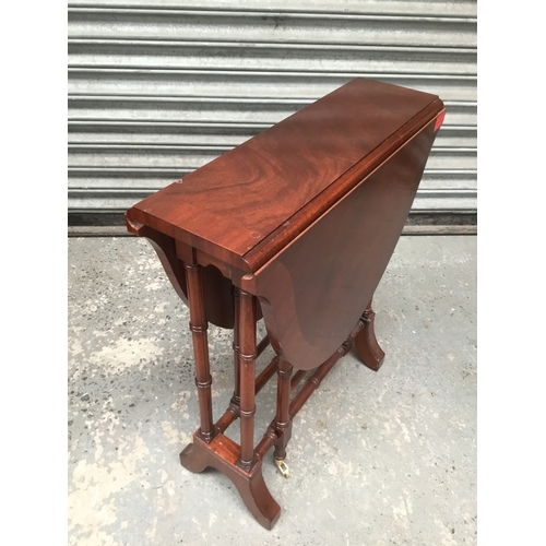 1050D - Small mahogany gate leg table with brass castors 84cm x 55cm x 63cm