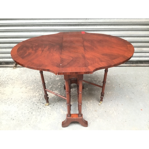 1050D - Small mahogany gate leg table with brass castors 84cm x 55cm x 63cm