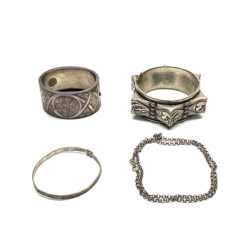 1031 - A white metal necklace, a standard silver bangle, and a Moroccan silver bracelet with a total weight... 