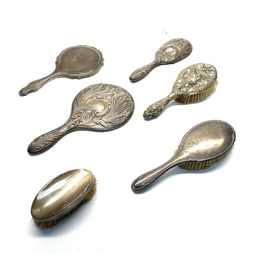 1032 - Collection of silver hair brushes and mirrors.