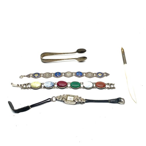 1033 - Sterling silver sugar tongs, a pen with mother-of-pearl, and two bracelets: one with a naval theme a... 
