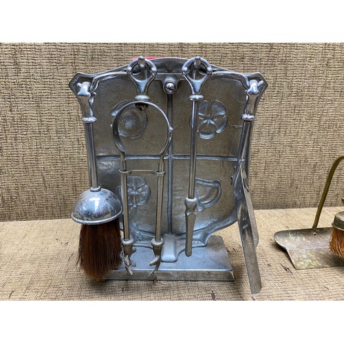 808 - decorative shield fireside companion and a brass dust brush.