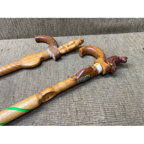 812 - 2 hand carved walking sticks.