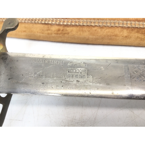 802 - Indian sabre with a brass tiger head handle in a decorative sheath. Strictly over 21 only, ID must m... 