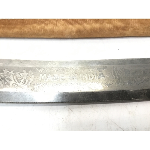 802 - Indian sabre with a brass tiger head handle in a decorative sheath. Strictly over 21 only, ID must m... 