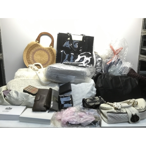 62A - A very large quantity of ladies handbags some retail packaged see both pictures