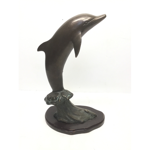 854 - Large bronzed dolphin figure on a wooden base 40cm