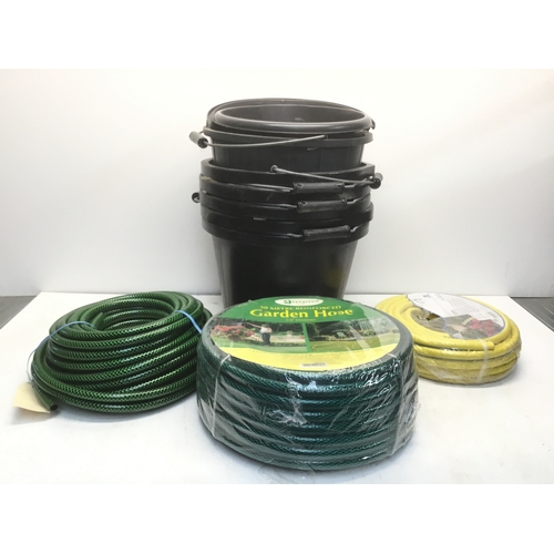 239 - Three hosepipe reels and seven plastic buckets