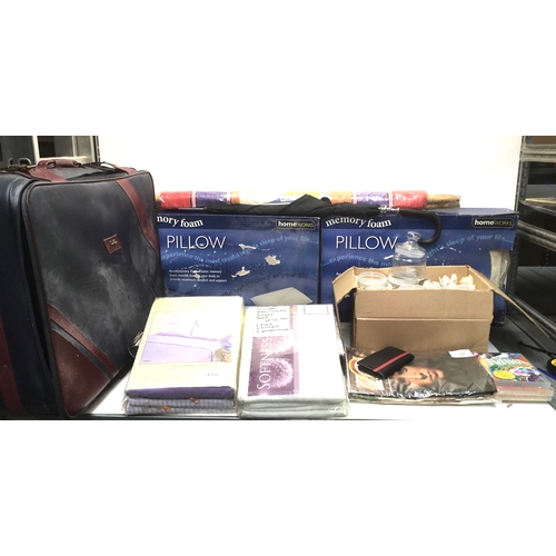 254 - Mixed items including retail packaged bedding, memory foam pillows and a set of graduated suitcases