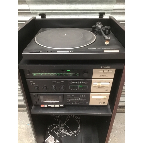 25 - Pioneer separates stereo system in a cabinet including turntable TX-530L, SA-530, CT-330 and PL-430