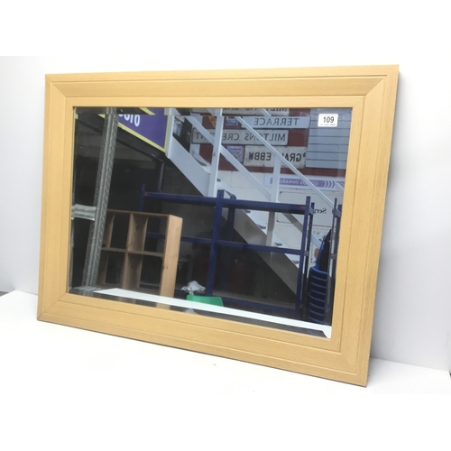 109 - Framed bevel edged mirror 85cm x 64cm